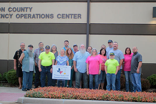 A group of various club members standing outside the Johnson County Emergency Operations Center.